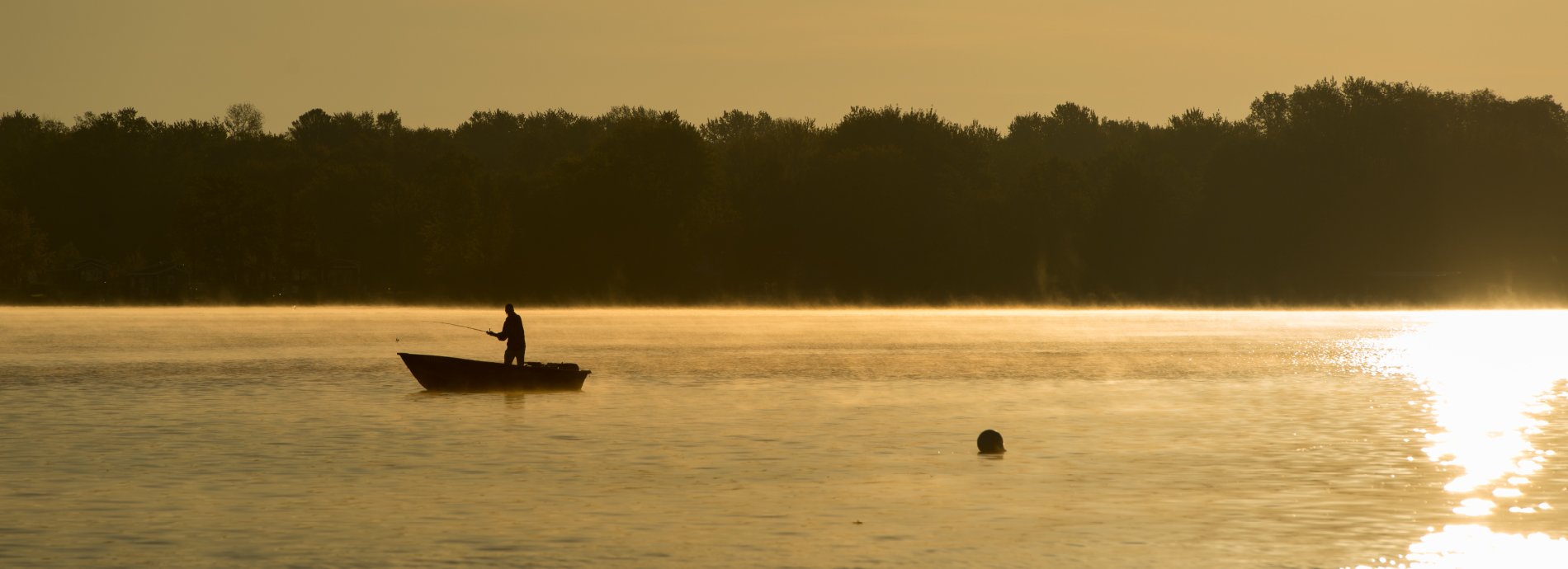 canoeists fishing at dusk