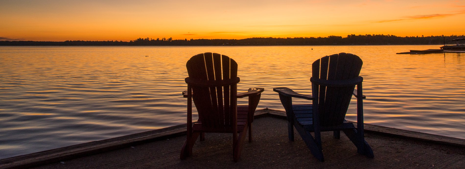 chairs on a dock at sunset