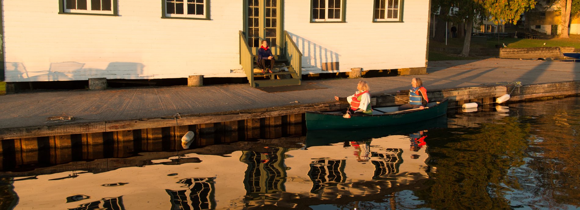paddlers resting alongside a wooden dock